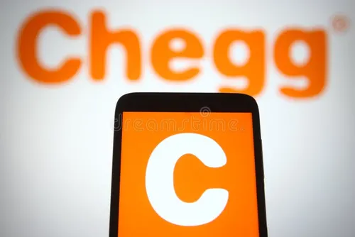 Photo of a smartphone with an orange app icon featuring a large white letter "C." In the background, the word "Chegg" is displayed in large, orange letters. It's the Chegg Inc logo and app.